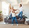 Family three generations  grandmother, mother and child dancing, jumping and laugh at home