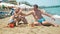 Family of three giving hi-fives on the beach