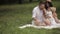 Family of three having a picnic in the glade