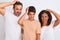 Family of three, mother, father and son standing over white isolated background confuse and wonder about question