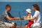 Family of three people resting on sea