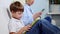 A family of three sit on the couch and uses digital devices. The boy using tablet and mother browsing information on the