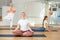 Family of three various aged women exercising yoga together