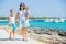 Family of three walking along tropical beach