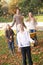 Family throwing autumn leaves into the air