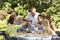 Family Toasting Wine Glasses At Table In Back Yard