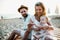 A family with a toddler girl sitting on sand beach on summer holiday.