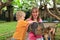 Family touching monitor lizard