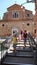 Family of tourists on the bridge next to a church in the city of