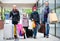 Family of tourists carrying shopping bags