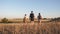 Family of tourists on journey. Dad with two daughters on a camping trip. children and father with backpacks are walking