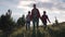 Family of tourists on a journey. mother with two daughters in the campaign. children with backpacks admire the view of