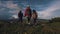 Family of tourists on a journey. mother with two daughters in the campaign. children with backpacks admire the view of