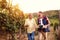 Family tradition smiling father and son harvesting grapes