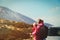 Family travel by car-mother with baby on road in mountains