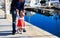 Family travel- father and little daughter learning to walk in port