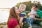 Family with two boys at the lake, sunny spring day.