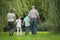 Family with two children in early fall park.