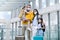 Family with two children going on holiday, wearing face masks at the airport.