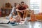 Family with two children playing gamed at home on the floor