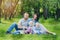 Family with two children rest in the summer garden