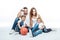 Family with two children sitting with basketball ball