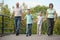 Family with two children is walking on bridge