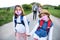 Family with two small daughters on trip outdoors in nature, wearing face masks.