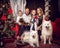 Family with two white dogs near the Christmas tree