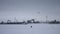 Family using a kite on frozen water storage