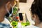 Family Using Phone With Empty Screen Buying Food In Supermarket