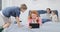 Family Using Tablet And Laptop Computer In Bedroom happy Parents Spending Time With Children At Home