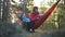 family vacation camping relax. dad, mom, little daughter on hammock together