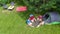 Family vacation in campsite aerial top view from above, parents and kids relax and have fun in park, tent and camping equipment