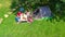 Family vacation in campsite aerial top view from above, parents and kids relax and have fun in park, tent and camping equipment