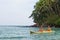 Family on vacation kayaking in the waters of Indian ocean