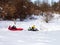 Family vacation in the mountains ,a frosty winter morning, riding on inflatable buns from the slides.