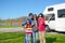Family vacation, RV travel with kids, parents with children have fun on holiday trip in motorhome, camper exterior