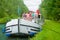 Family vacation, summer holiday travel on barge boat in canal, happy kids and parents having fun on river cruise trip in houseboat