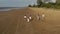 Family vacation in summer. Young asian family walking on beach. Big friendly family with three children