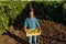 Family Vineyard. senior attractive farmer, hereditary winemaker working on a grape field in the harvest season.