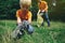 Family of volunteers with children collecting garbage in park. Save environment concept. Little boy and his father cleaning up the