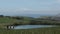 Family walk towards the Dorset coast through green fields and hills