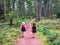 A family walking along a pathway surrounded by beautiful forest on Newcastle Island, outside Nanaimo, British Columbia, Canada.