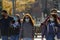 A family walking in the park with face masks on