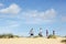 Family Walking Sand Dune On Beach