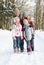 Family Walking Through Snowy Woodland