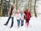 Family Walking Through Snowy Woodland