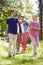 Family Walking Through Summer Countryside