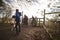 Family walking their dog pass through a gate in countryside